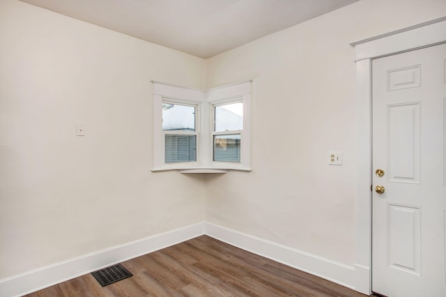 918 Kalamazoo Ave SE, Grand Rapids, MI 49507 - spare room featuring baseboards and dark wood-style flooring
