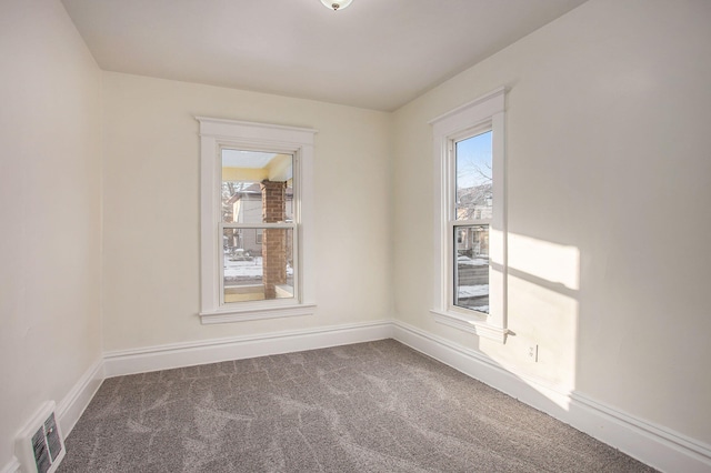 918 Kalamazoo Ave SE, Grand Rapids, MI 49507 - carpeted empty room with plenty of natural light and baseboards
