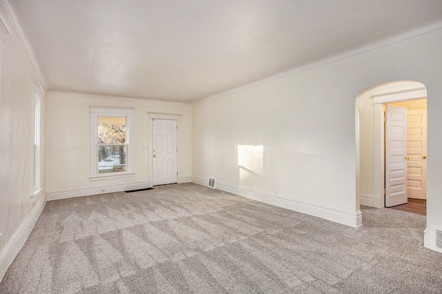 918 Kalamazoo Ave SE, Grand Rapids, MI 49507 - empty room featuring carpet floors, arched walkways, and baseboards