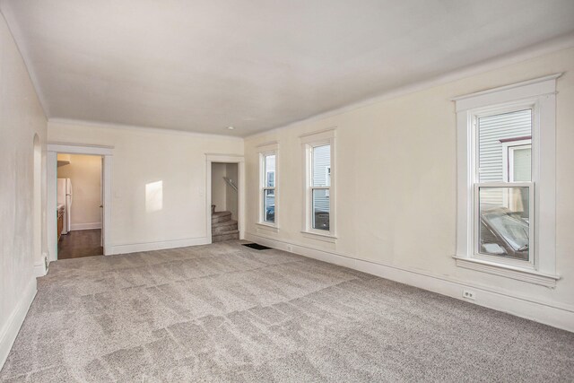 918 Kalamazoo Ave SE, Grand Rapids, MI 49507 - carpeted empty room featuring stairs and baseboards