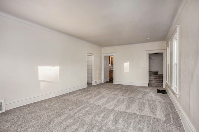 918 Kalamazoo Ave SE, Grand Rapids, MI 49507 - unfurnished bedroom featuring carpet flooring, arched walkways, and baseboards