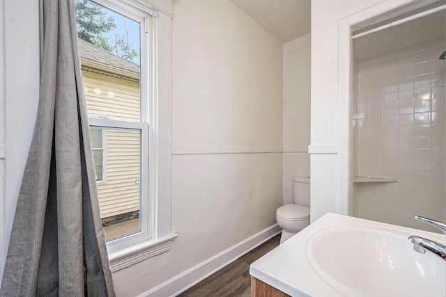 918 Kalamazoo Ave SE, Grand Rapids, MI 49507 - bathroom with wood finished floors, baseboards, toilet, and a sink