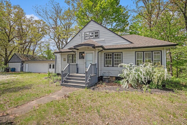7566 Red Arrow Hwy, Stevensville, MI 49127 - bungalow-style home featuring a front yard, roof with shingles, and central AC