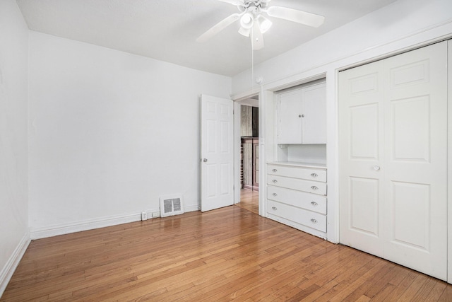 7566 Red Arrow Hwy, Stevensville, MI 49127 - unfurnished bedroom with light wood-style floors, baseboards, and a ceiling fan