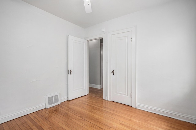 7566 Red Arrow Hwy, Stevensville, MI 49127 - unfurnished bedroom featuring light wood-style flooring, baseboards, and a ceiling fan