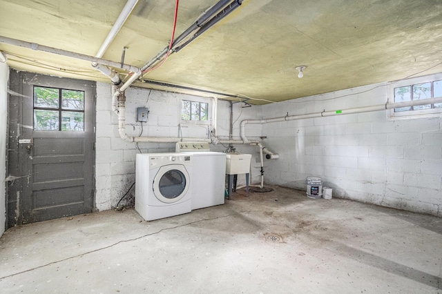 7566 Red Arrow Hwy, Stevensville, MI 49127 - below grade area featuring washing machine and dryer, concrete block wall, plenty of natural light, and a sink