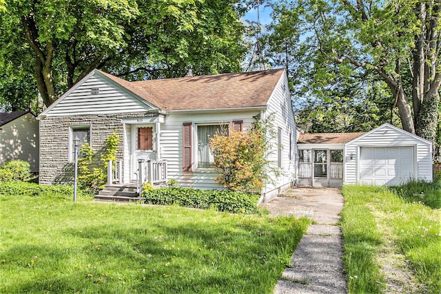 bungalow-style home with a front lawn, roof with shingles, and driveway