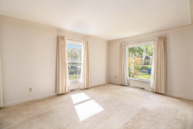 empty room with carpet floors and baseboards