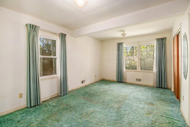 carpeted spare room with baseboards
