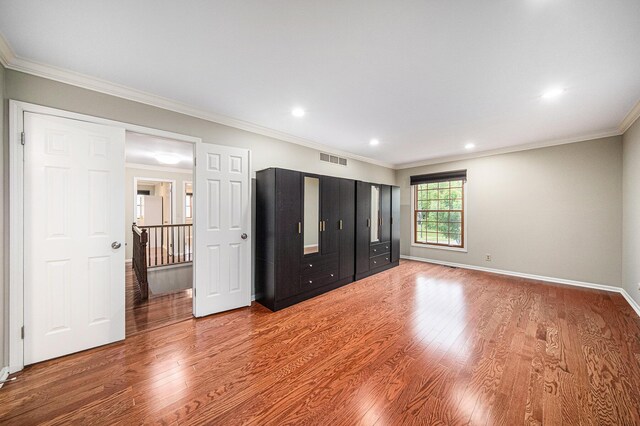 3630 Charter Pl, Ann Arbor, MI 48105 - unfurnished bedroom with wood finished floors, baseboards, ornamental molding, and recessed lighting