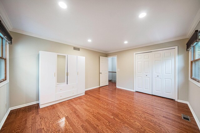 3630 Charter Pl, Ann Arbor, MI 48105 - unfurnished bedroom featuring light wood-style floors, baseboards, crown molding, recessed lighting, and a closet