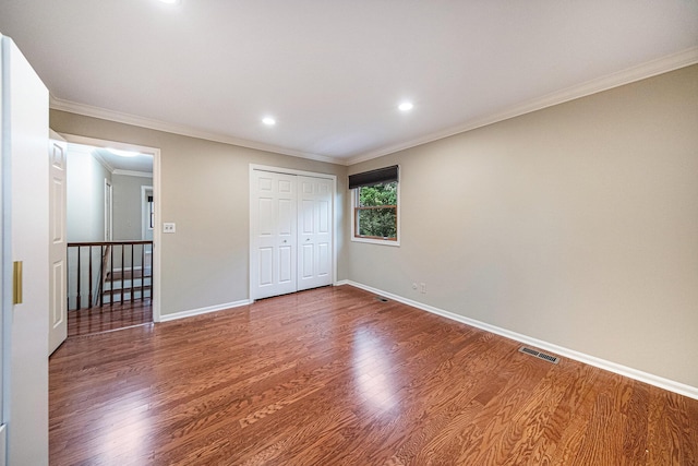 3630 Charter Pl, Ann Arbor, MI 48105 - unfurnished bedroom with wood finished floors, crown molding, baseboards, recessed lighting, and a closet