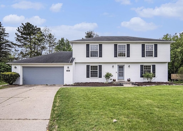 3630 Charter Pl, Ann Arbor, MI 48105 - colonial-style house with concrete driveway, a garage, a front yard, and brick siding