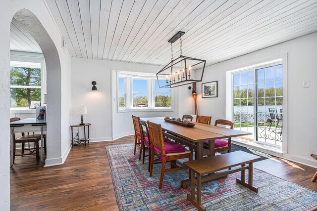 8700 E Napier Ave, Benton Harbor, MI 49022 - dining room featuring dark wood-style flooring, arched walkways, wood ceiling, a chandelier, and baseboards