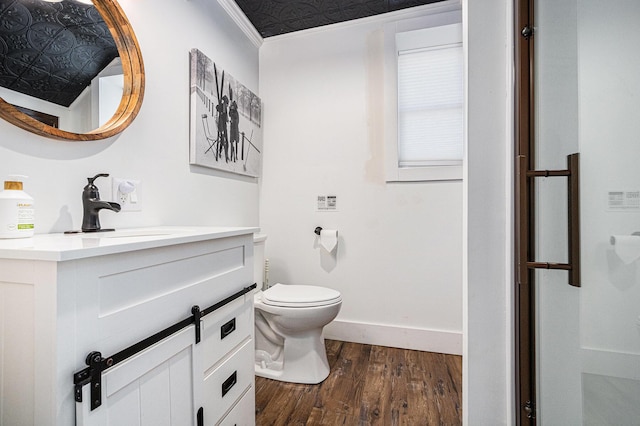 8700 E Napier Ave, Benton Harbor, MI 49022 - full bathroom featuring wood finished floors, toilet, vanity, baseboards, and a shower