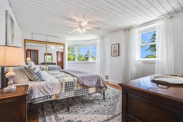 8700 E Napier Ave, Benton Harbor, MI 49022 - bedroom with wood ceiling, multiple windows, a closet, wood finished floors, and a ceiling fan