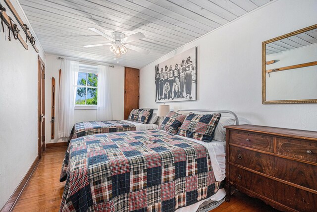 8700 E Napier Ave, Benton Harbor, MI 49022 - bedroom with wood finished floors, wood ceiling, baseboards, and ceiling fan