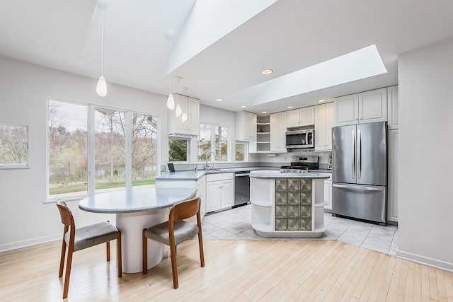 2277 W Huron River Dr, Ann Arbor, MI 48103 - kitchen with appliances with stainless steel finishes, open shelves, a sink, light wood-type flooring, and pendant lighting