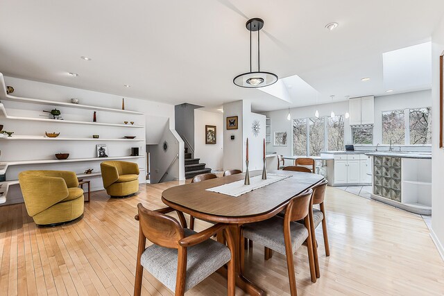 2277 W Huron River Dr, Ann Arbor, MI 48103 - dining space featuring light wood-style flooring, stairs, and recessed lighting
