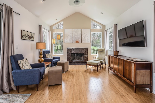 2277 W Huron River Dr, Ann Arbor, MI 48103 - living room with lofted ceiling, a fireplace, and light wood-type flooring