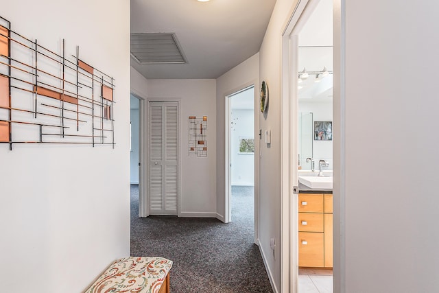 2277 W Huron River Dr, Ann Arbor, MI 48103 - corridor featuring a sink, carpet flooring, and baseboards