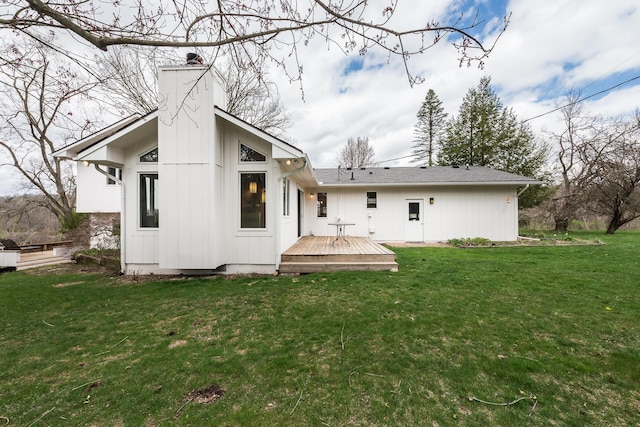 2277 W Huron River Dr, Ann Arbor, MI 48103 - back of house featuring a chimney, a deck, and a lawn