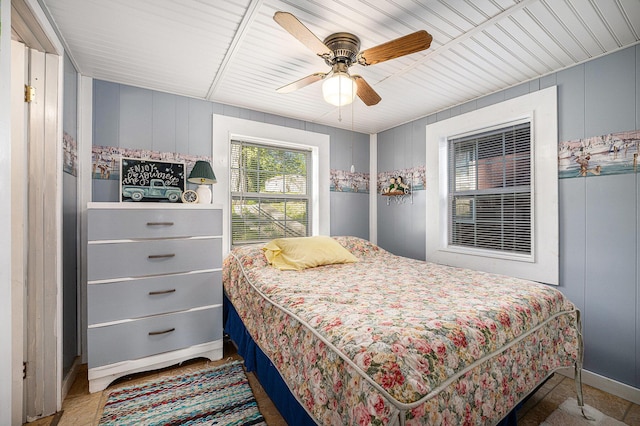 3309 Dumont Lake Dr, Allegan, MI 49010 - bedroom with a ceiling fan, a decorative wall, and baseboards
