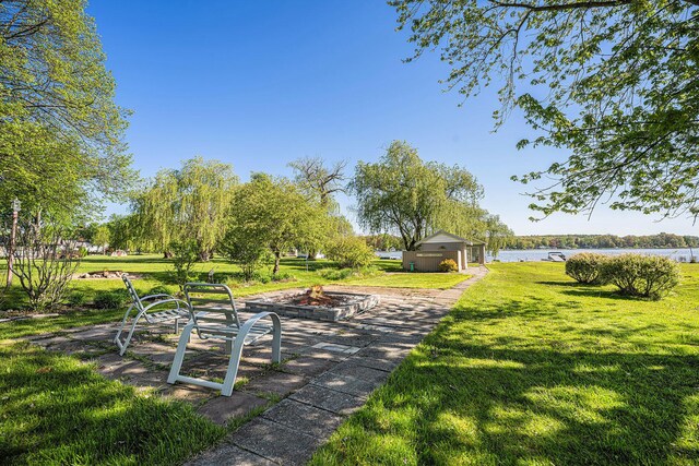 3309 Dumont Lake Dr, Allegan, MI 49010 - view of home's community featuring an outdoor fire pit, a yard, and a water view