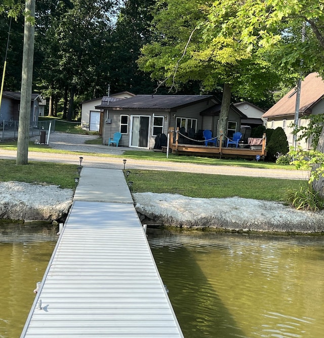 6439 E Sugar Grove Rd, Fountain, MI 49410 - dock featuring a yard and a deck with water view