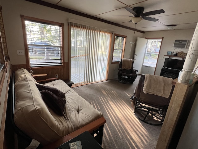 6439 E Sugar Grove Rd, Fountain, MI 49410 - carpeted living room featuring ceiling fan, a wainscoted wall, a wall mounted air conditioner, and wooden walls
