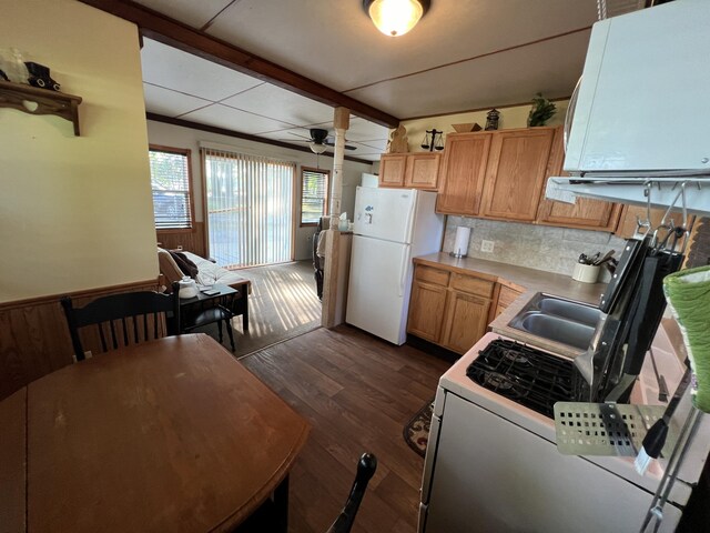 6439 E Sugar Grove Rd, Fountain, MI 49410 - kitchen featuring freestanding refrigerator, dark wood-style flooring, light countertops, backsplash, and a ceiling fan