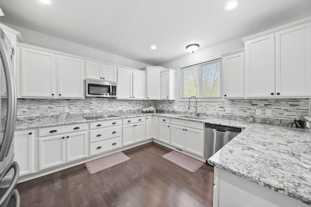 10478 River Edge Rd, Saline, MI 48176 - kitchen with stainless steel appliances, a sink, white cabinetry, recessed lighting, and tasteful backsplash