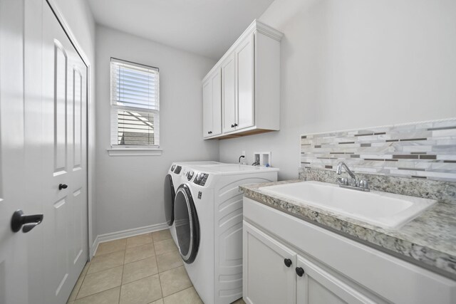 10478 River Edge Rd, Saline, MI 48176 - clothes washing area with washer and dryer, cabinet space, light tile patterned floors, and baseboards