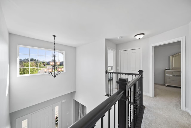 10478 River Edge Rd, Saline, MI 48176 - hallway featuring an upstairs landing, a chandelier, carpet floors, and baseboards