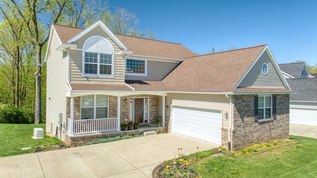 10478 River Edge Rd, Saline, MI 48176 - traditional-style house with covered porch, concrete driveway, an attached garage, and a front lawn