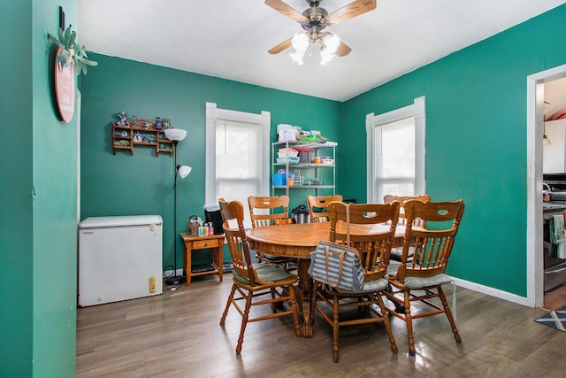 404 Oak St, Dowagiac, MI 49047 - dining area with a ceiling fan, wood finished floors, and baseboards