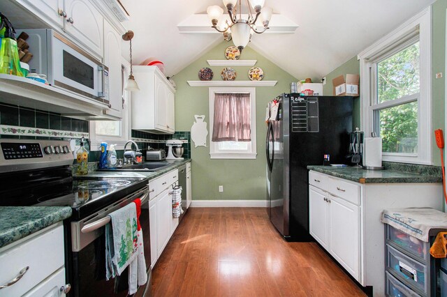 404 Oak St, Dowagiac, MI 49047 - kitchen featuring stainless steel appliances, white cabinets, wood finished floors, a sink, and baseboards
