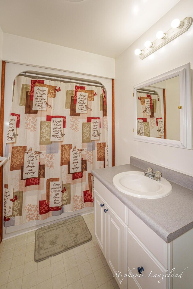 16913 Penny Ave NE, Sand Lake, MI 49343 - bathroom with vanity, tile patterned flooring, and a shower with shower curtain