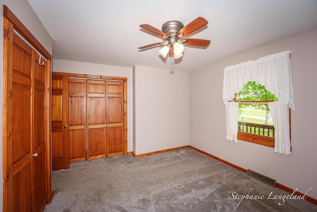 16913 Penny Ave NE, Sand Lake, MI 49343 - unfurnished bedroom with baseboards, carpet, a closet, and a ceiling fan