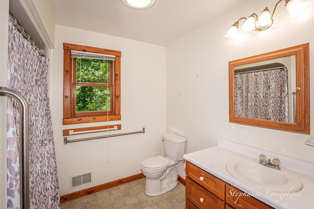 16913 Penny Ave NE, Sand Lake, MI 49343 - bathroom featuring baseboards, vanity, and toilet