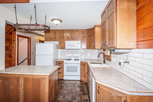 16913 Penny Ave NE, Sand Lake, MI 49343 - kitchen with white appliances, a sink, brown cabinets, light countertops, and stone finish floors