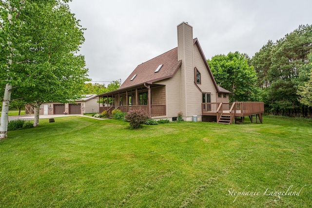 16913 Penny Ave NE, Sand Lake, MI 49343 - back of property featuring a lawn, an outdoor structure, a deck, a shingled roof, and a chimney