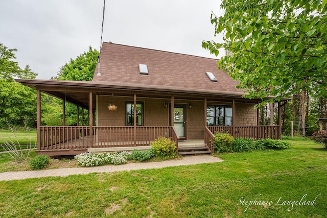 16913 Penny Ave NE, Sand Lake, MI 49343 - view of front of home with a front lawn, a shingled roof, and a porch