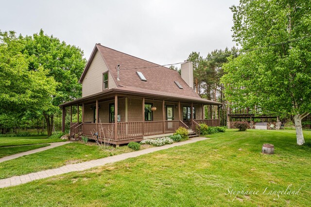 16913 Penny Ave NE, Sand Lake, MI 49343 - farmhouse featuring a porch, a chimney, a front yard, and roof with shingles