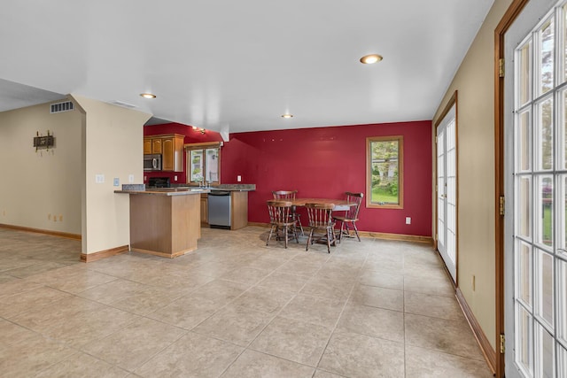 186 Goldsmith Dr, Clarklake, MI 49234 - kitchen featuring appliances with stainless steel finishes, a peninsula, plenty of natural light, recessed lighting, and light tile patterned floors