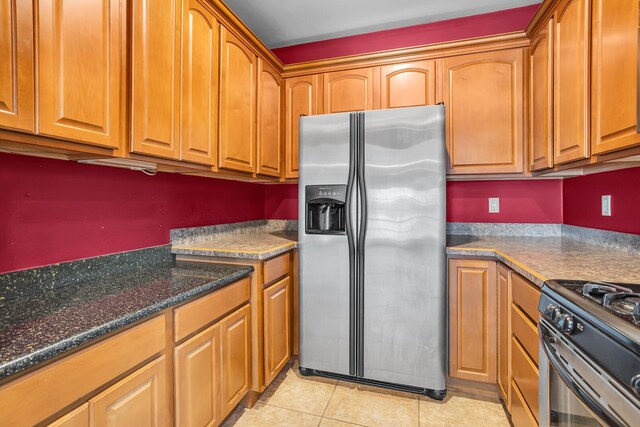 186 Goldsmith Dr, Clarklake, MI 49234 - kitchen featuring stainless steel refrigerator with ice dispenser, light tile patterned floors, and brown cabinets