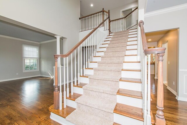 7294 Mackenzie Ln, Portage, MI 49024 - stairs with ornamental molding, wood finished floors, baseboards, a towering ceiling, and recessed lighting