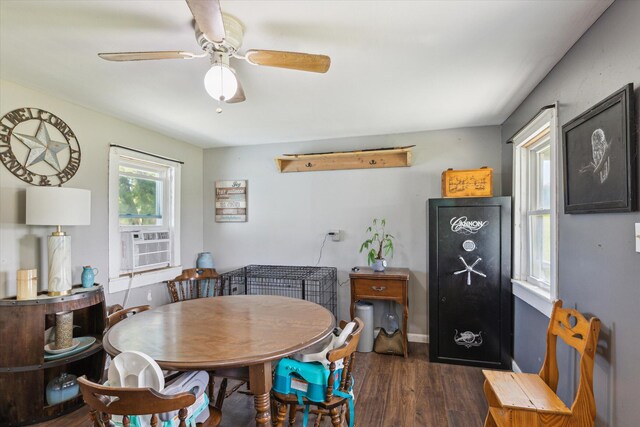 dining room featuring wood finished floors, cooling unit, and a ceiling fan