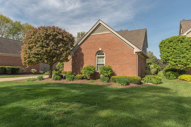 4980 Doral Dr, Ann Arbor, MI 48108 - view of side of home with brick siding and a yard