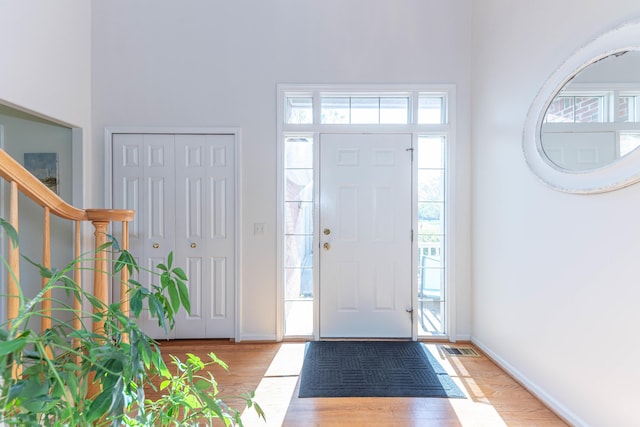 4980 Doral Dr, Ann Arbor, MI 48108 - entryway featuring wood finished floors, baseboards, and stairs